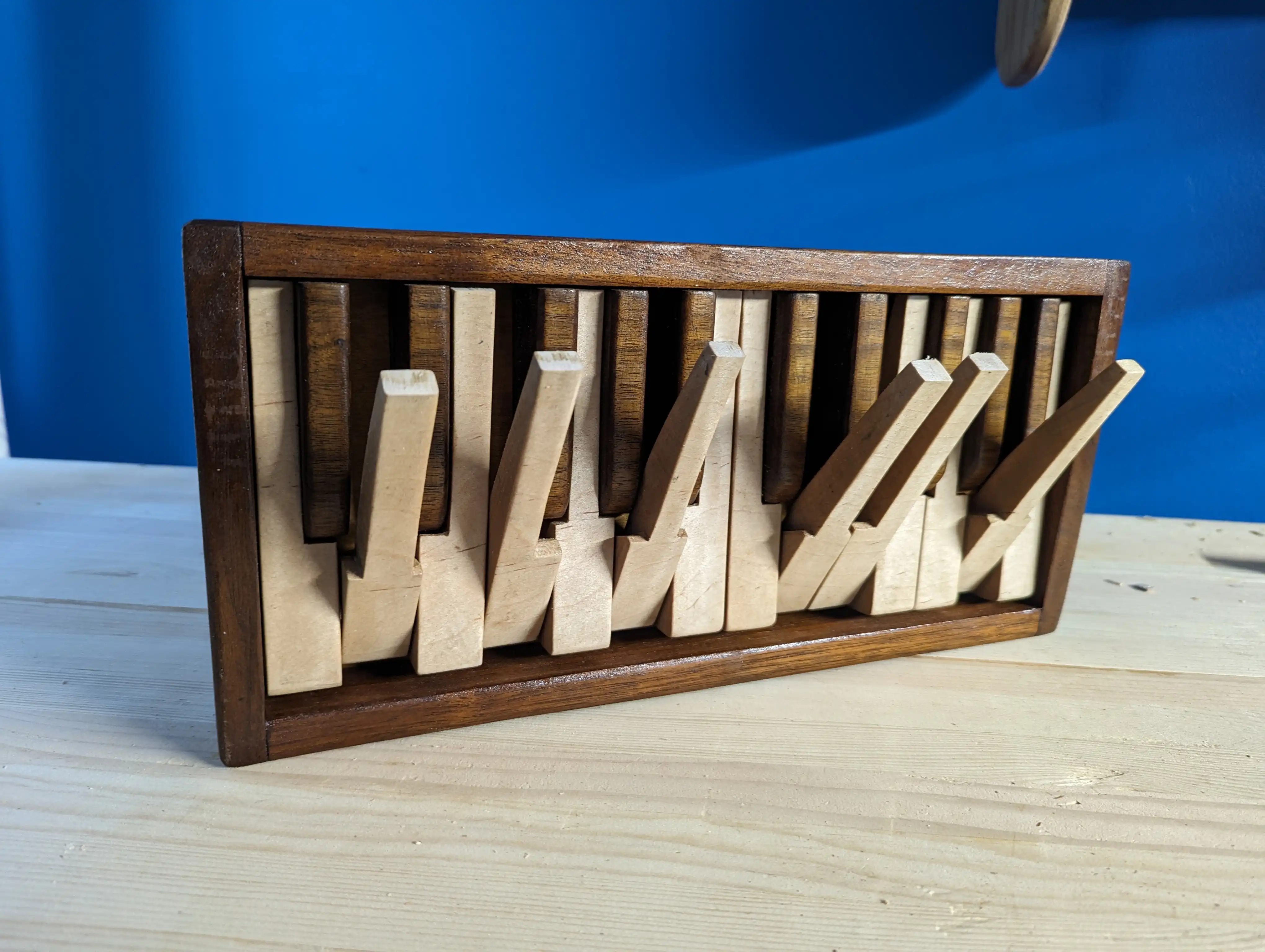 A picture of a piano coatrack with keys extended to use as hooks