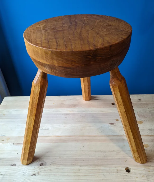 A round wooden stool